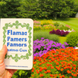 Description: A person holding a copy of the Farmers Almanac with a beautiful garden in the background.