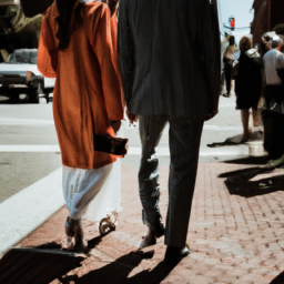 description: an anonymous image shows a young couple smiling and walking together in a city. their outfits are trendy and fashionable, reflecting their status as hollywood celebrities. the image captures their chemistry and happiness, suggesting a strong bond between them.